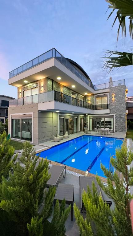 an exterior view of a house with a swimming pool at Living Dream Villa RELAX in Belek