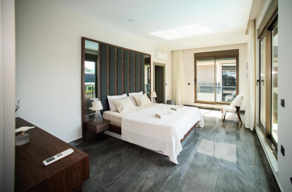 a bedroom with a large white bed and a window at Living Dream Villa RELAX in Belek