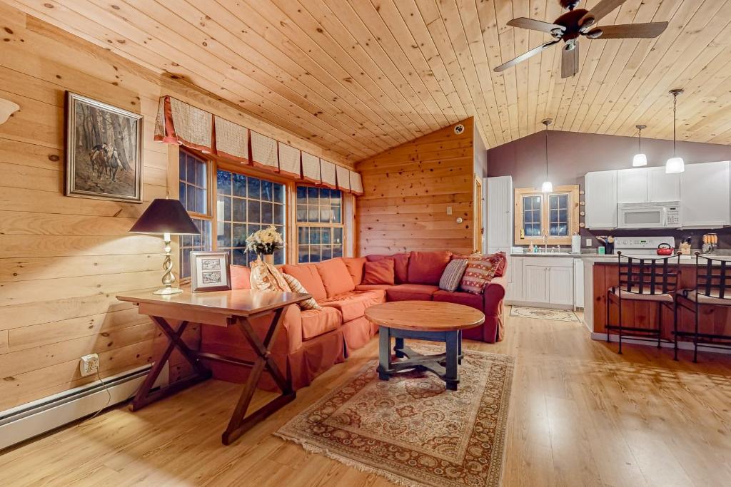 a living room with a couch and a table at The Loft at Pine Rock in Weston