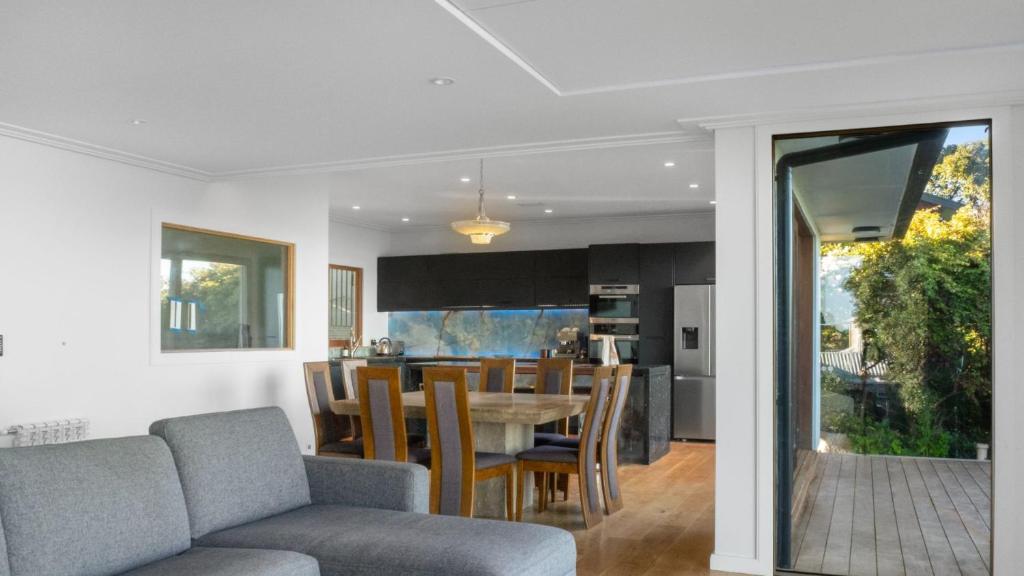 a dining room and kitchen with a table and chairs at Sunset Haven in Nelson in Nelson