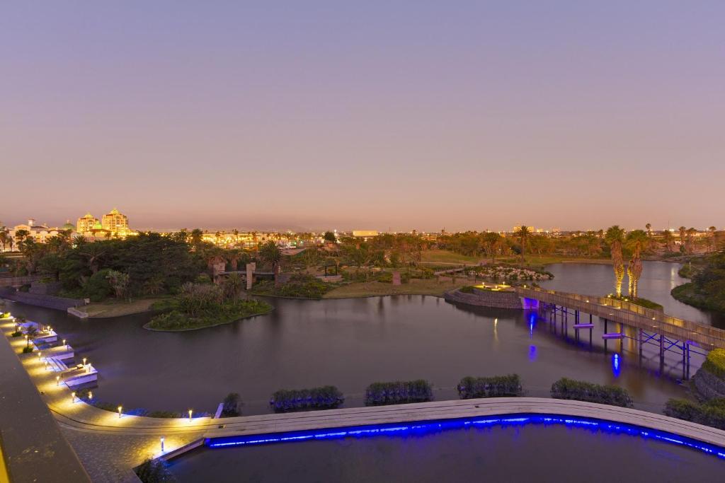 a view of a river at night at Bridgewater View 502 by HostAgents in Cape Town