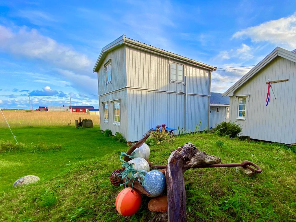 a house with a pile of balls in front of it at Kleivan Cabin Lofoten in Kvalnes