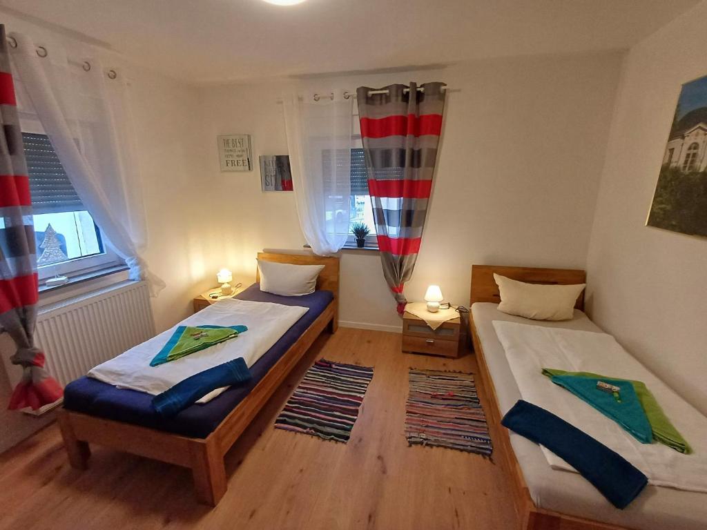 a bedroom with two beds and a window at APARTMENTS / WOHNUNG IN HAIBACH in Haibach