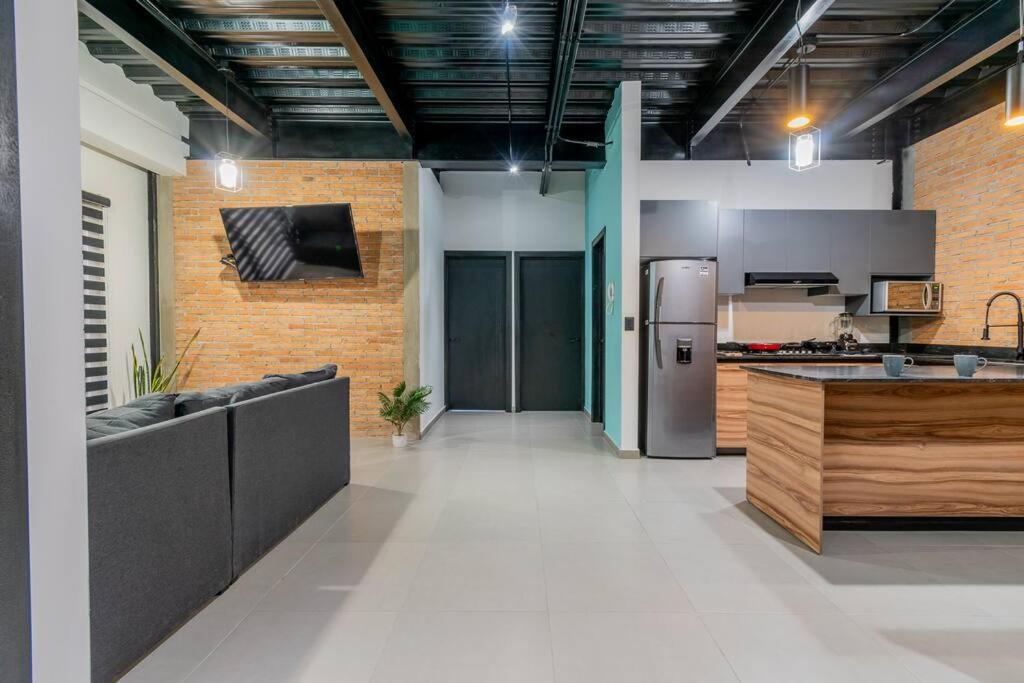 a large kitchen with a refrigerator in a room at Depa Industrial Moderno #1 in Durango