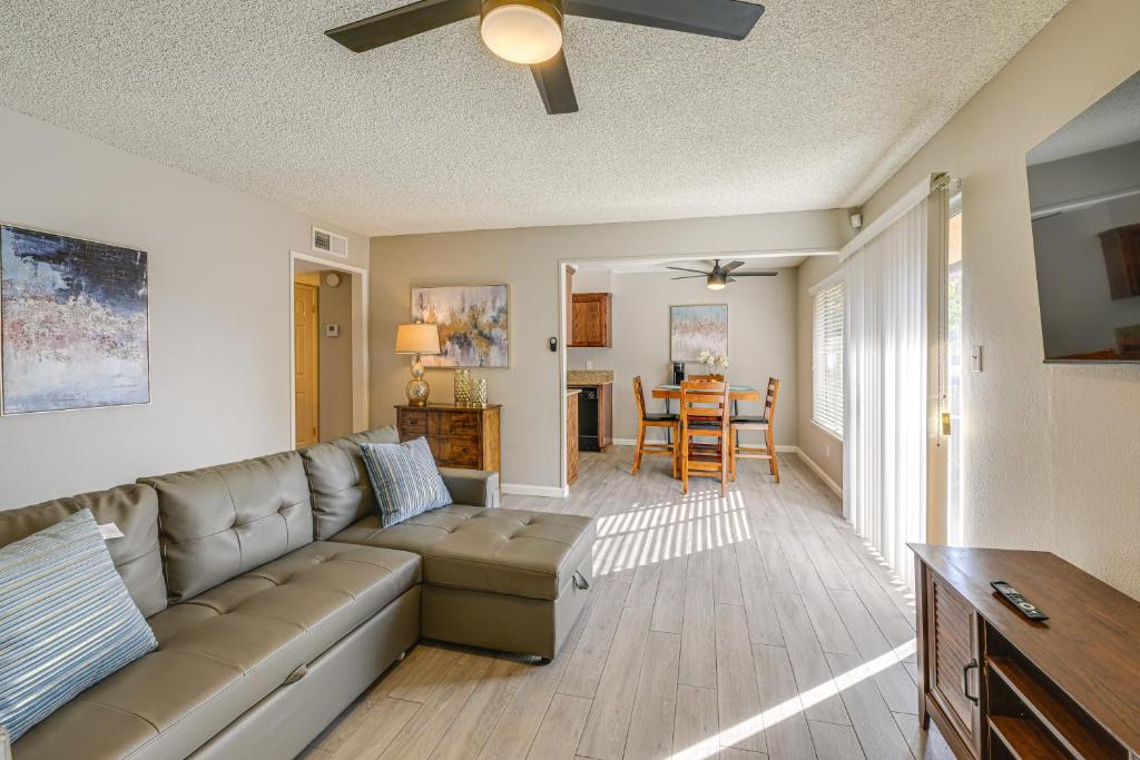 a living room with a couch and a table at Cozy Fresno Condo with Balcony and Pool Access in Fresno