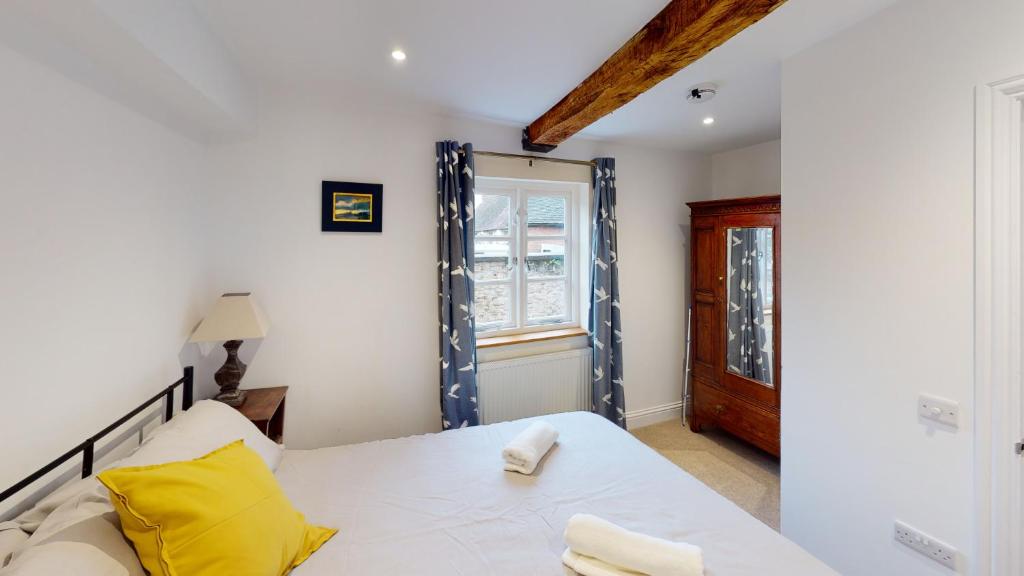 a bedroom with a bed and a window at Ludlow Escapes - Ludlow Town Centre Apartments in Ludlow