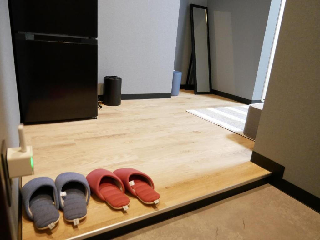 a row of shoes sitting on a wooden floor at HOOD - Vacation STAY 46041v in Amami