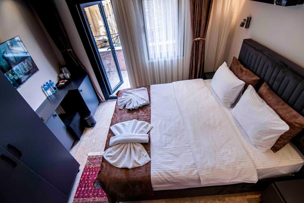 a bedroom with a large bed and a window at Sea view room with Balcony,in middle of AyaSofia in Istanbul
