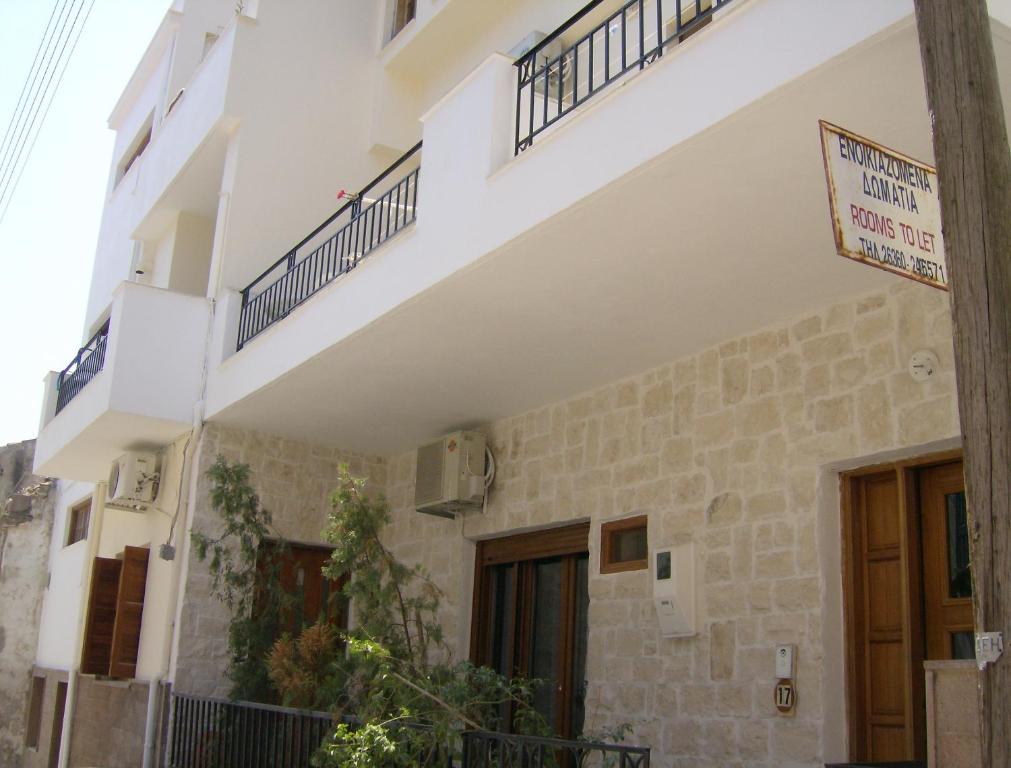 a building with a sign in front of it at Vazakas Rooms in Mytilene