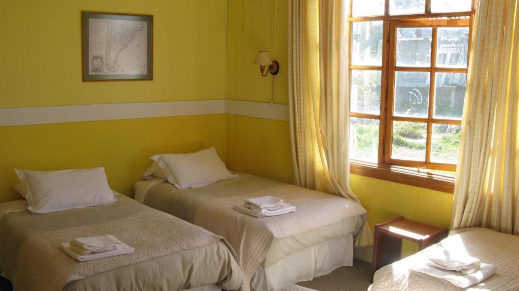 Postel nebo postele na pokoji v ubytování Yendegaia House