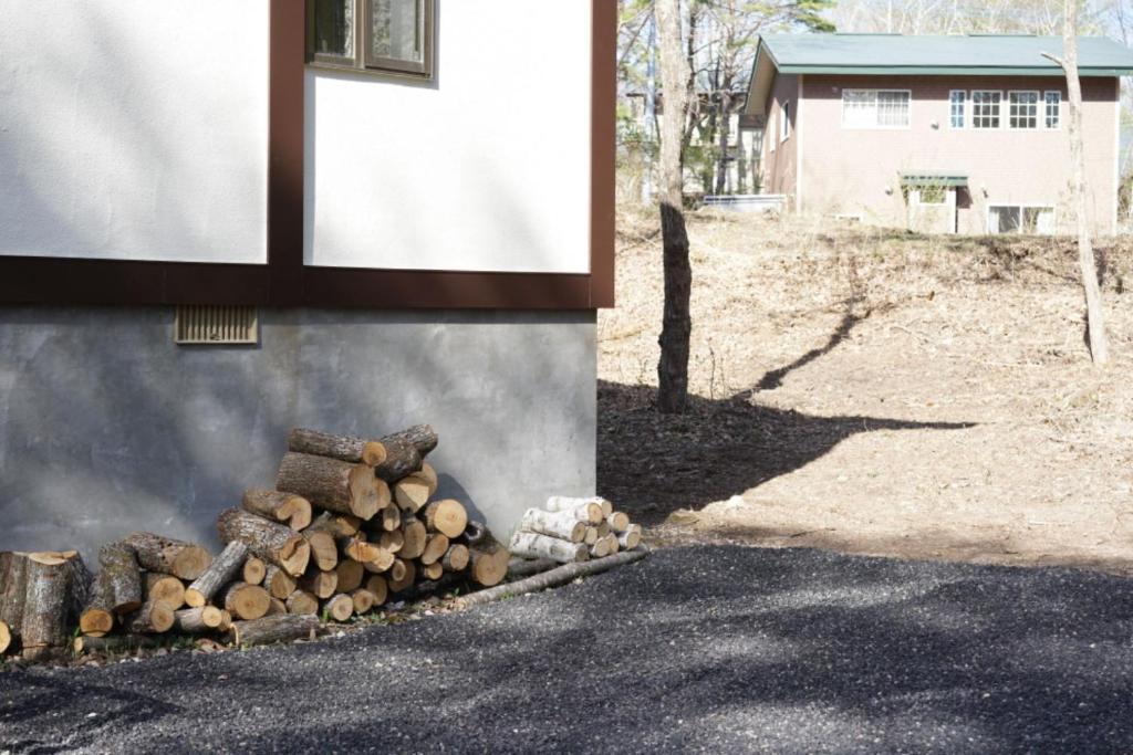 a pile of fire wood next to a building at Hoshi no Machi No, 177 - Vacation STAY 39992v in Tsumagoi