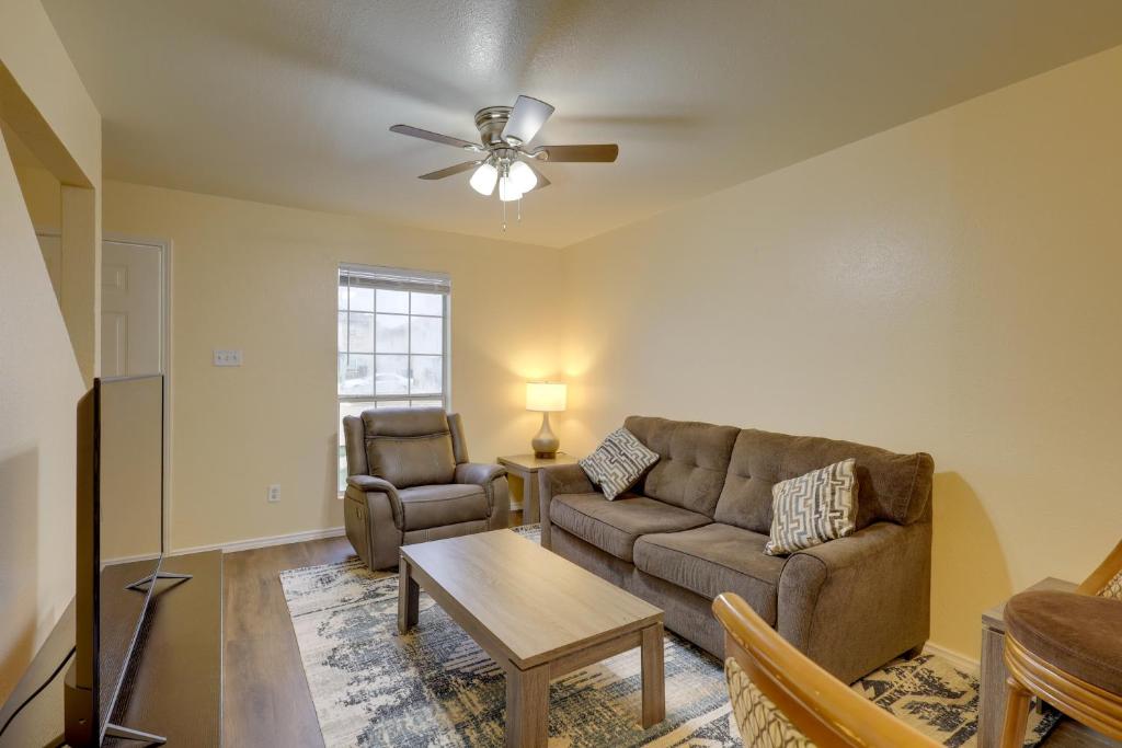 a living room with a couch and a table at Quiet Killeen Townhome, 5 Mi to Fort Hood Shopping in Killeen