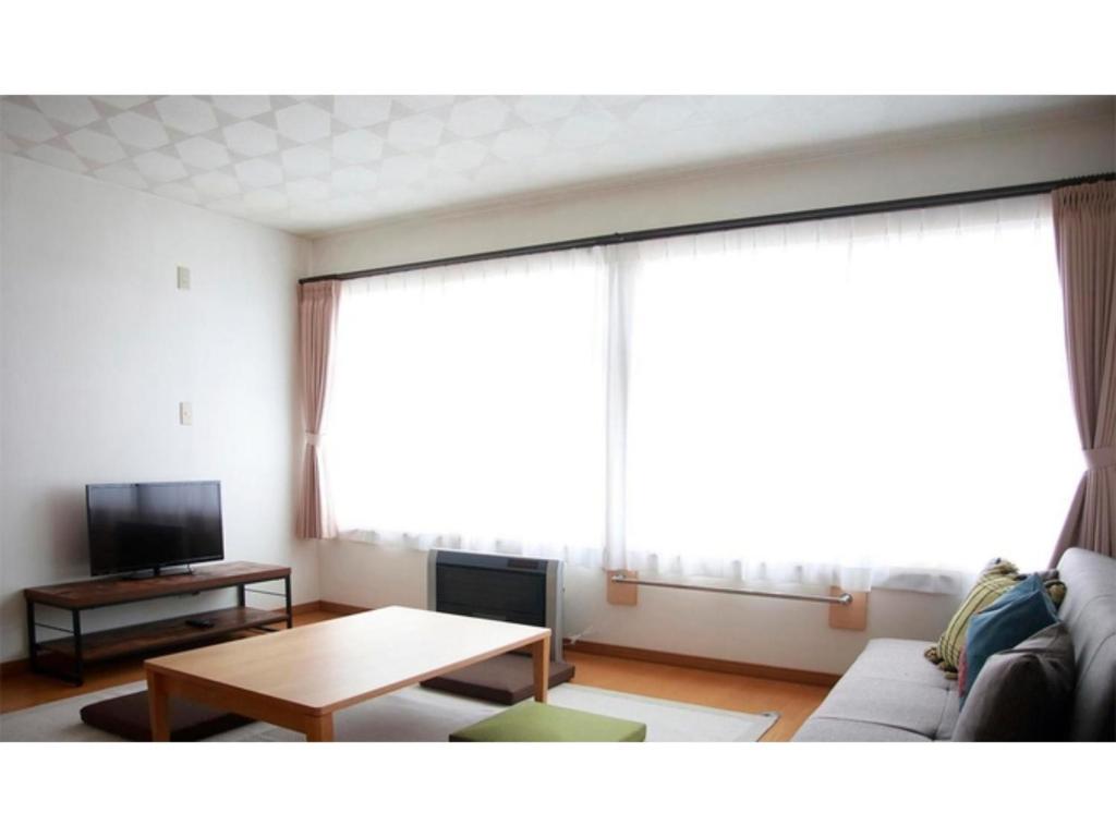 a living room with a couch and a table at THE STAY WAKKANAI - Vacation STAY 40729v in Wakkanai