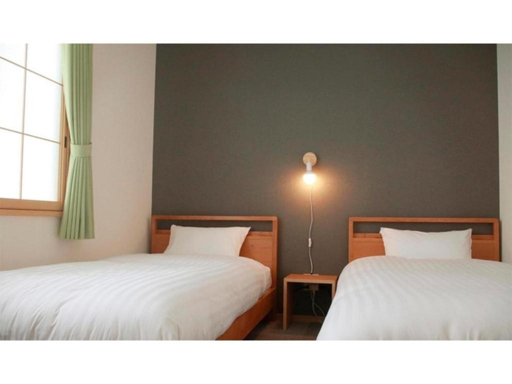 a room with two beds and a window at THE STAY WAKKANAI - Vacation STAY 40679v in Wakkanai