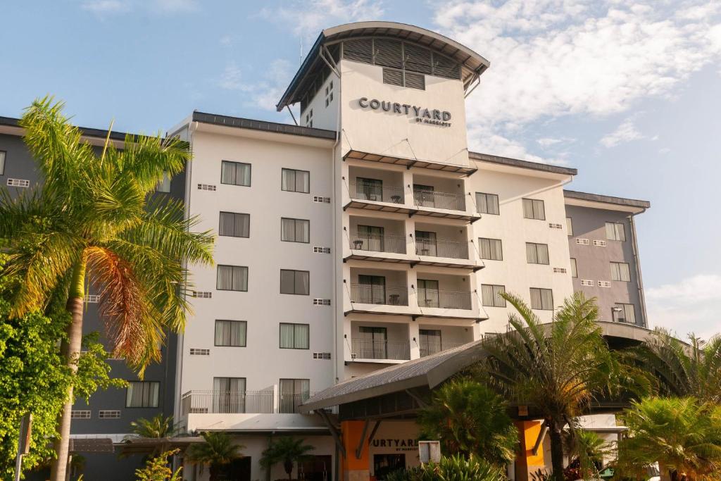 a hotel with a tower on top of it at Courtyard by Marriott San Salvador in San Salvador