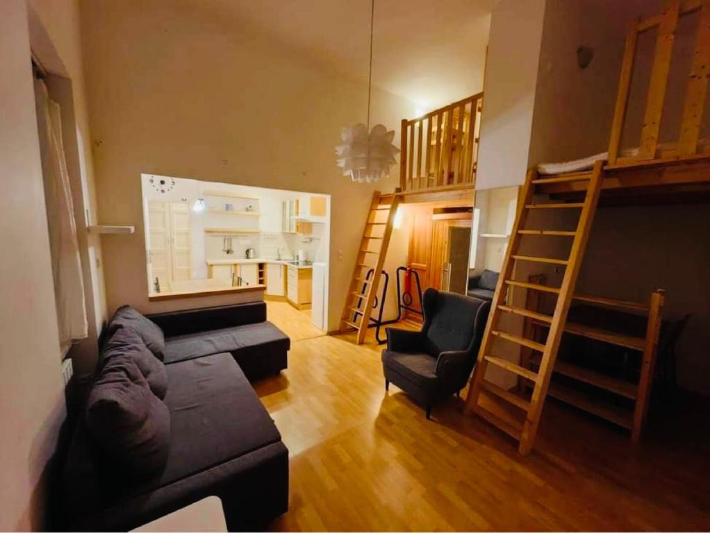 sala de estar con sofá, sillas y escalera en Downtown Apartment Bianca en Bratislava