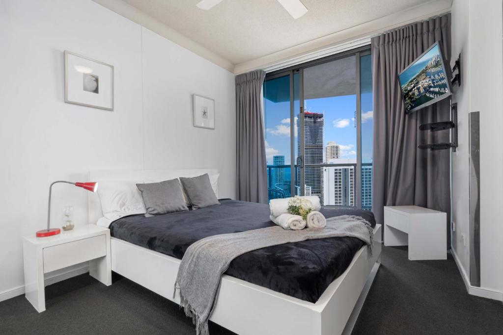 a bedroom with a bed and a large window at Ocean Views at Surfers Paradise - Chevron Renaissance - 2 Bedroom Apartment - Wow Stay in Gold Coast