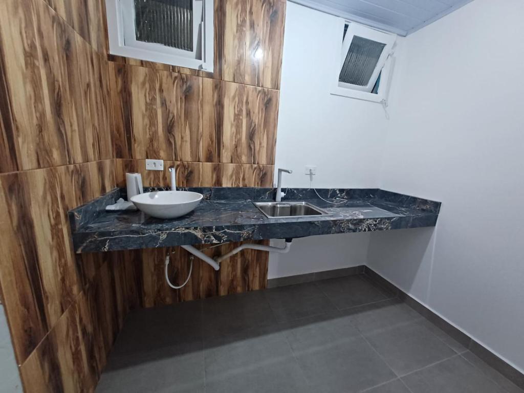 a bathroom with a counter with a sink in it at Ocker Pousada in Guarujá