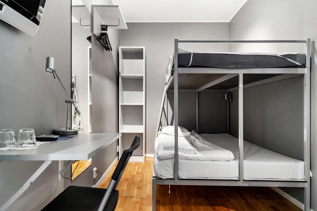 a room with a desk and bunk beds at Sure Hotel by Best Western Stockholm Alvsjo in Stockholm