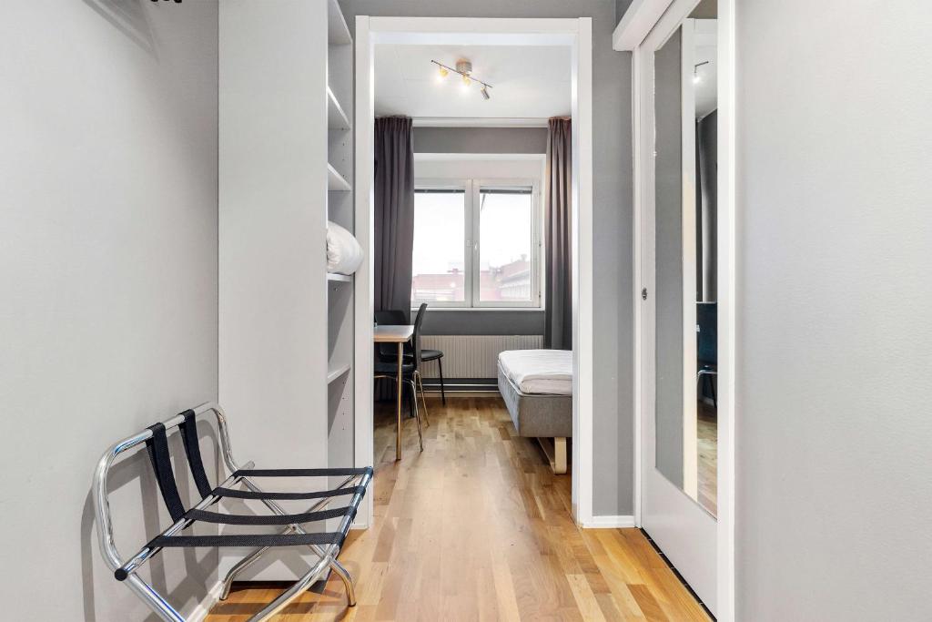 a hallway with a chair in a room at Sure Hotel by Best Western Stockholm Alvsjo in Stockholm