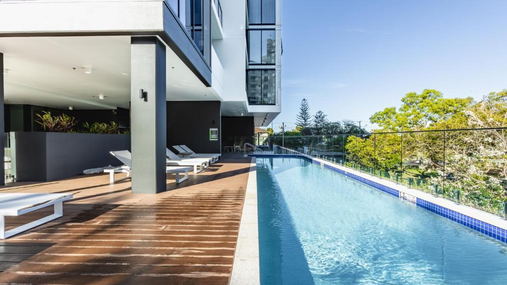 an external view of a house with a swimming pool at Sandbar Burleigh in Gold Coast
