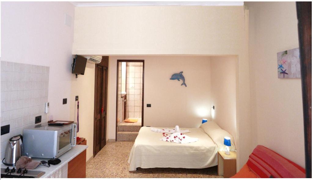 カリアリにあるCagliari Centroのベッド1台付きの部屋、壁にイルカが飾られた部屋