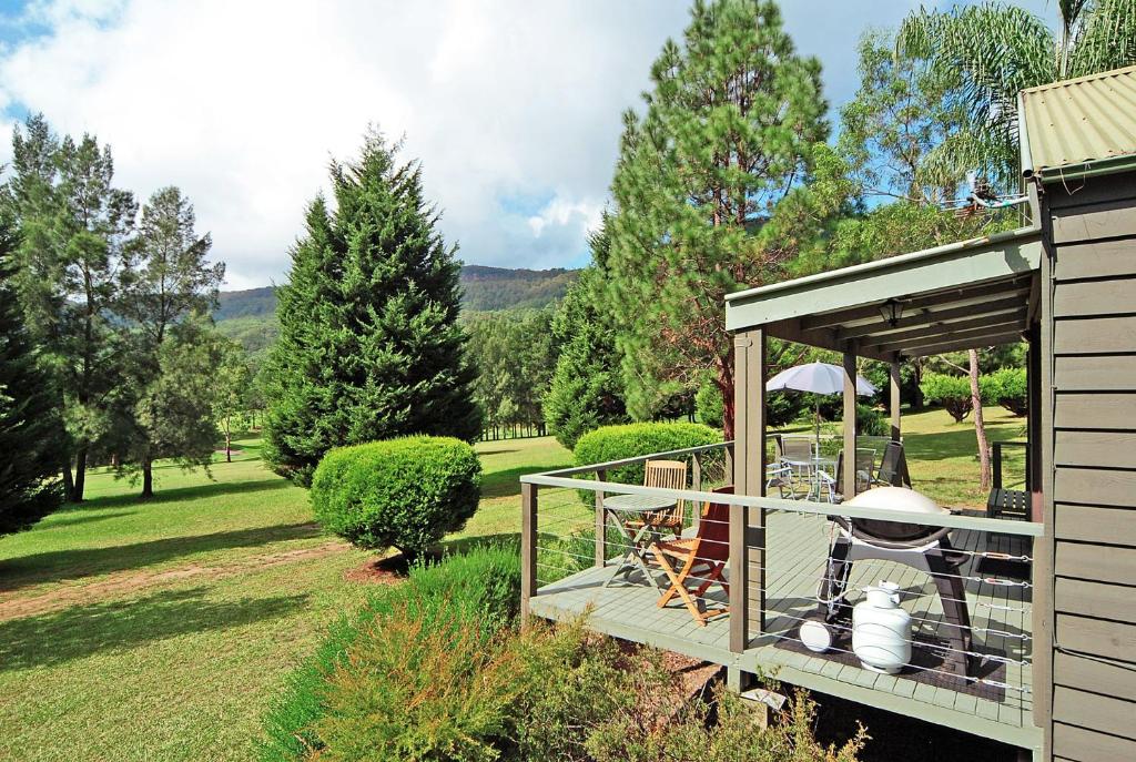 a gazebo with a table and chairs in it at Blue Gums Cottage in Kangaroo Valley