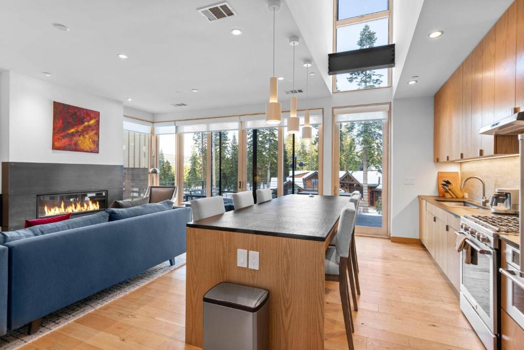 an open kitchen and living room with a fireplace at New Listing! Stellar Ski In Out Northstar Townhome, HOA Amenities in Truckee
