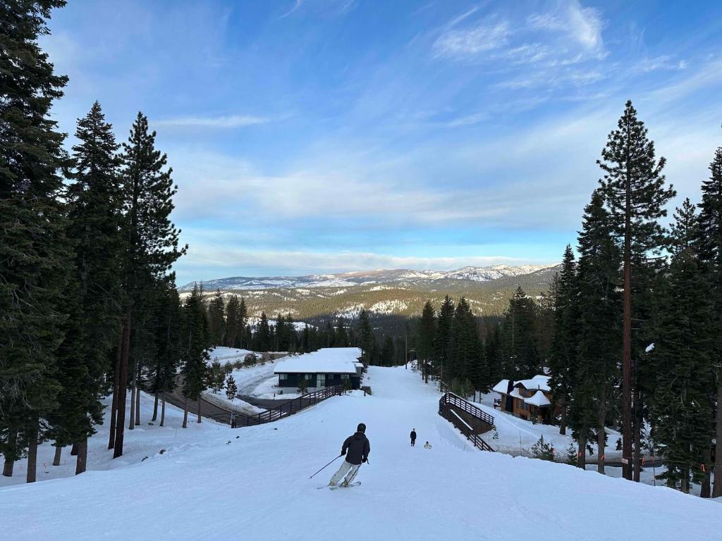 a man is skiing down a snow covered slope at Stellar Ski In Ski Out # 2 Northstar Townhome, HOA Amenities in Truckee