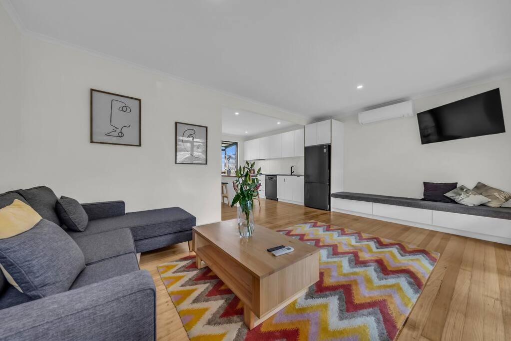 a living room with a couch and a coffee table at The Woodpecker in Merimbula