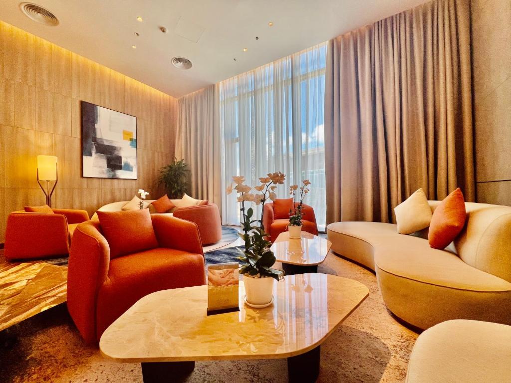 a living room with orange furniture and a large window at Panoramic sea homestay in Ha Long