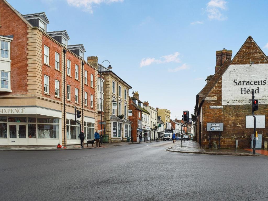 an empty street in an old town with buildings at Racing Retreat in Towcester
