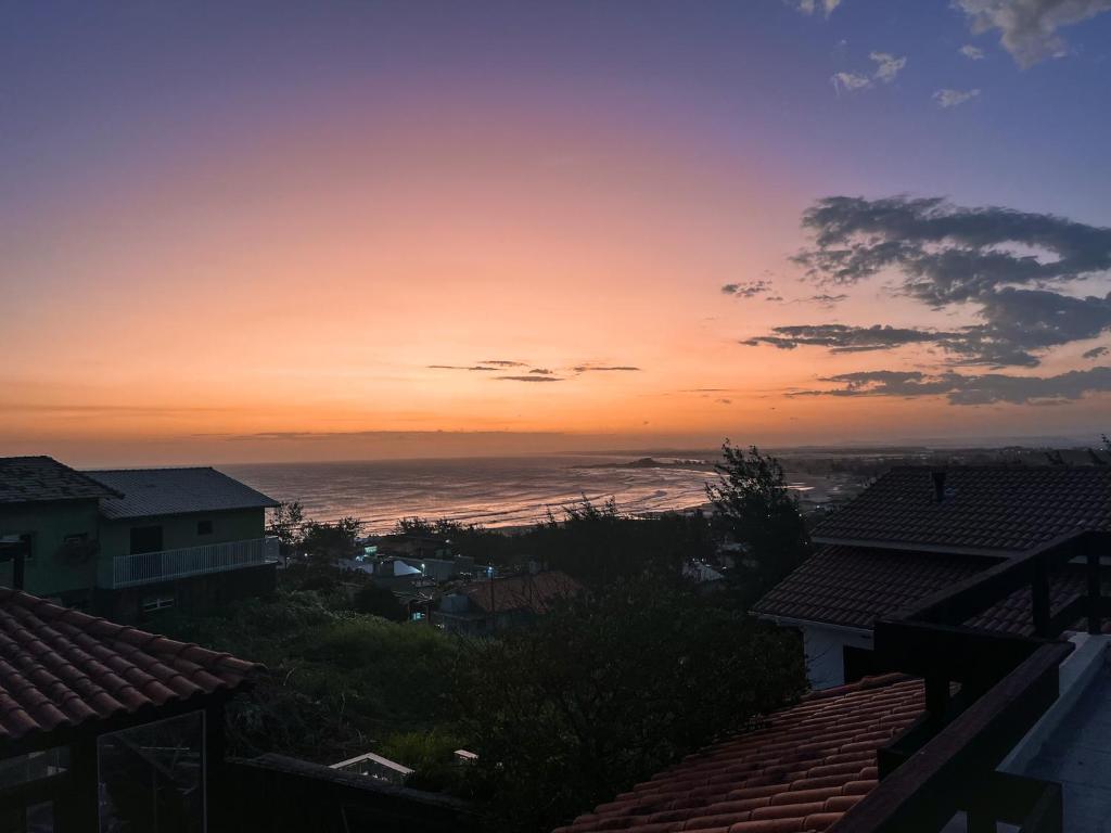 a view of the ocean at sunset from a house at Casa 2 - Estrela Dalva in Farol de Santa Marta