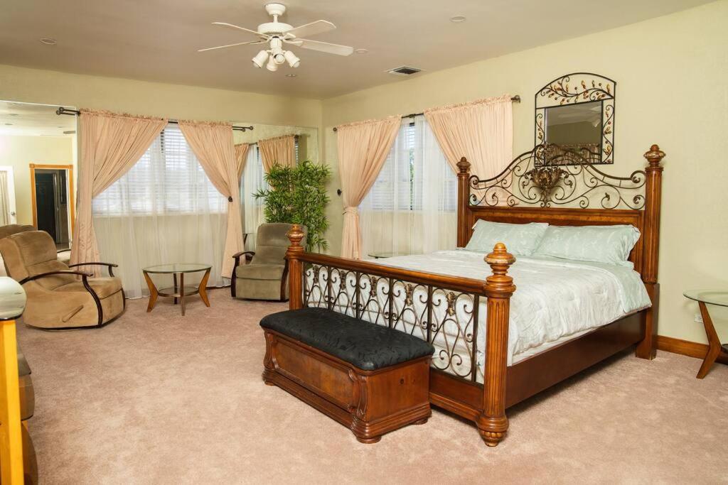 a bedroom with a bed with a mirror and a chair at Luxe Oasis: w/Pool & Lake Access in Nassau