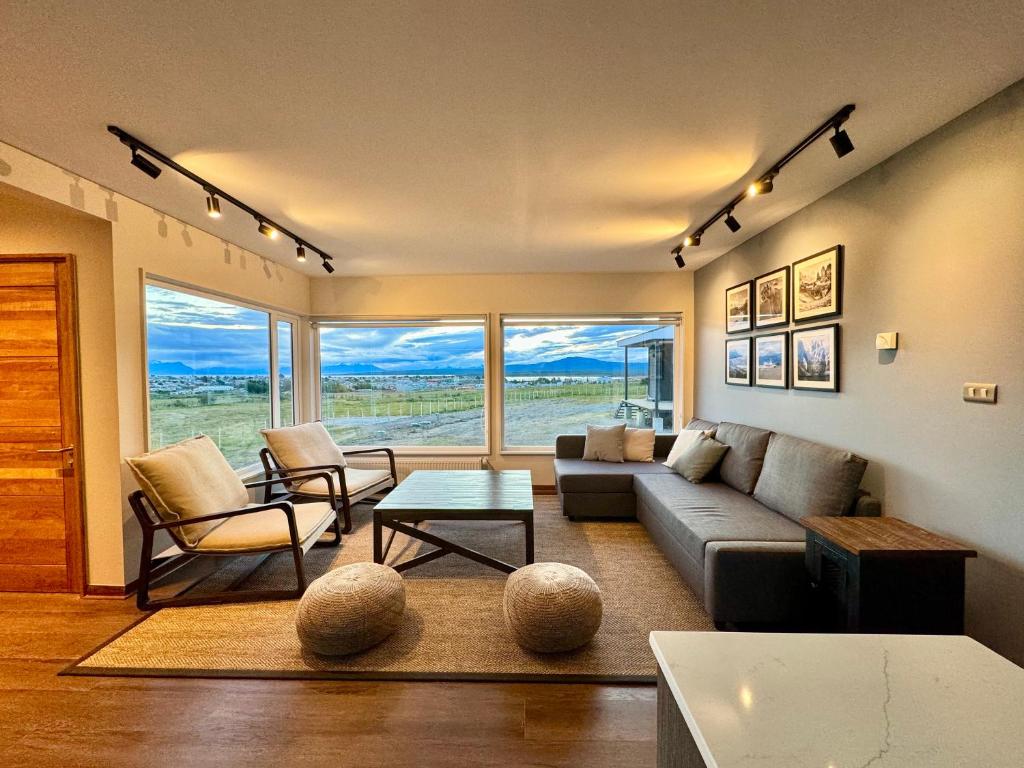 a living room with a couch and a table at Cabañas Los Coihues in Puerto Natales