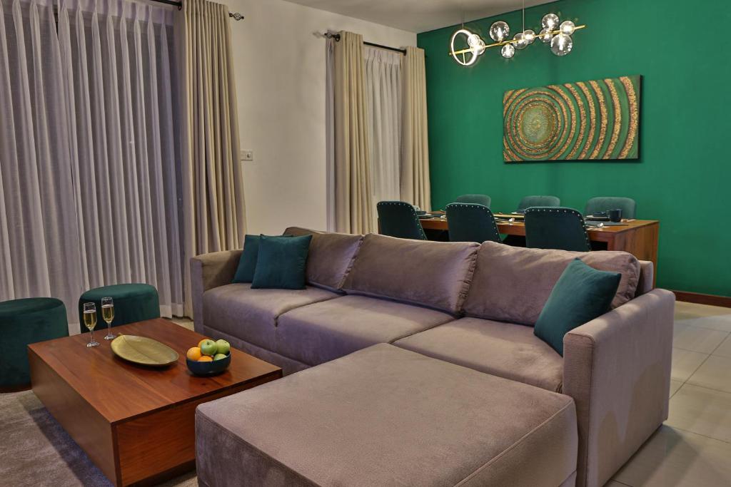 a living room with a couch and a table at EMERALD@On320 in Colombo