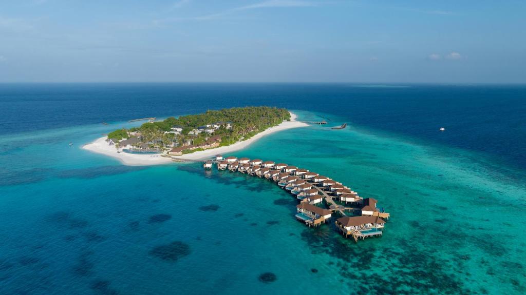 an island with a resort in the ocean at Avani Plus Fares Maldives Resort in Baa Atoll