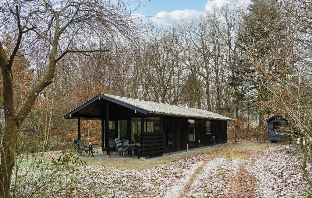a wooden cabin in the middle of a forest at 3 Bedroom Awesome Home In Silkeborg in Silkeborg