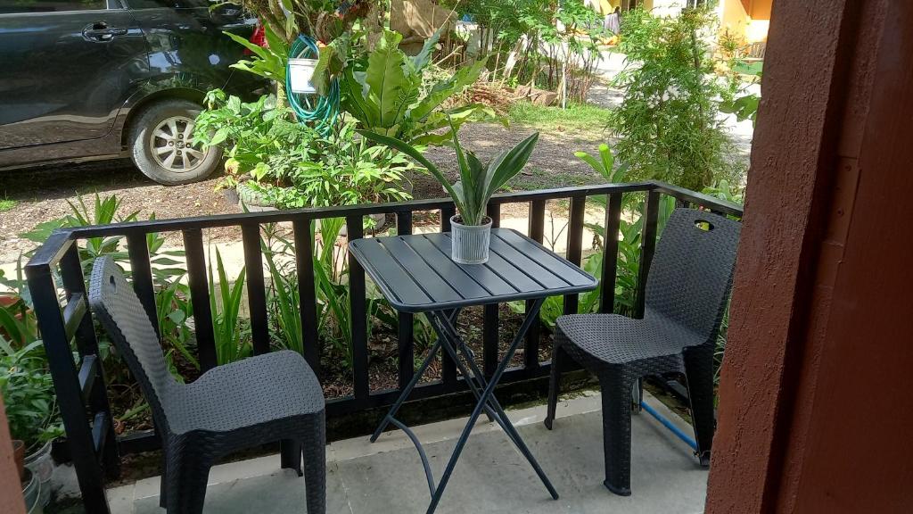 a small table and two chairs on a balcony at QuiapoSuites Bohol in Tagbilaran City