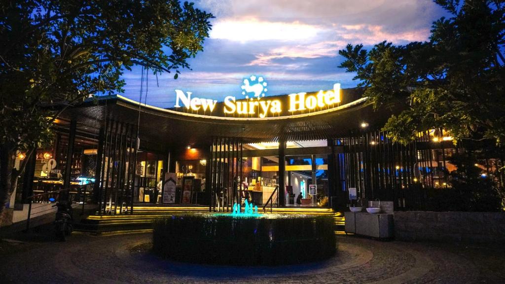 a new sylvania house at night with a sign at New Surya Hotel in Banyuwangi