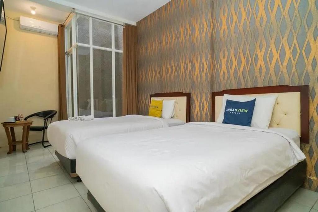 Postel nebo postele na pokoji v ubytování Urbanview Hotel Omah Anin Batu by RedDoorz