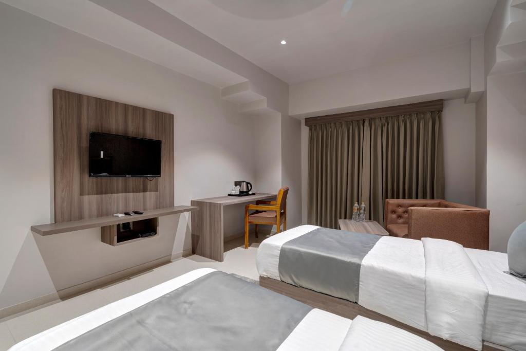 Postel nebo postele na pokoji v ubytování Hotel Sparsh Divine