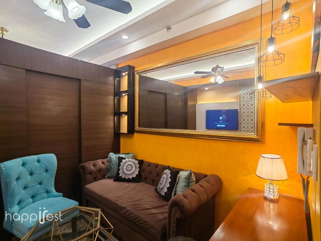 sala de estar con sofá y espejo en Happirest at SMDC Air Residences Makati en Manila