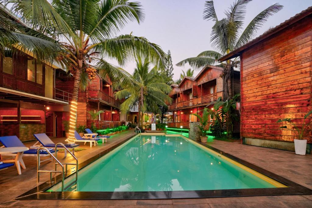 ein Schwimmbad in der Mitte eines Resorts in der Unterkunft Aqua Marina Beach Cottages in Calangute