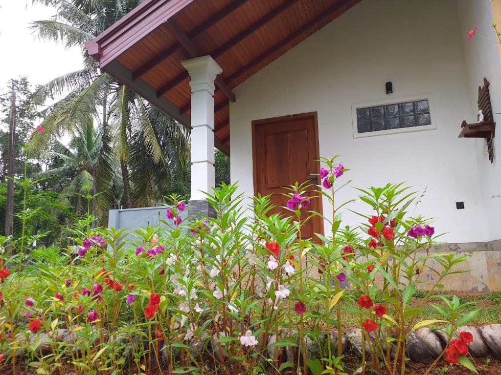 a house with a bunch of flowers in front of it at Bel vedere in Katunayake