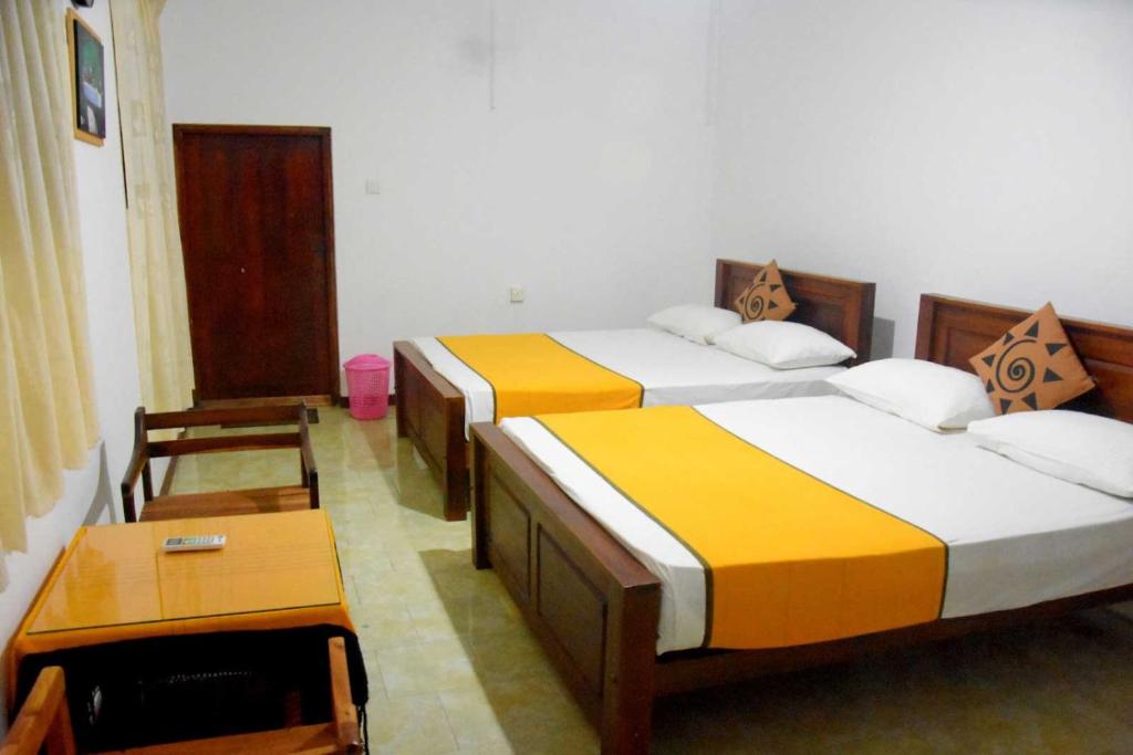 Postel nebo postele na pokoji v ubytování Yellow Birds Resort