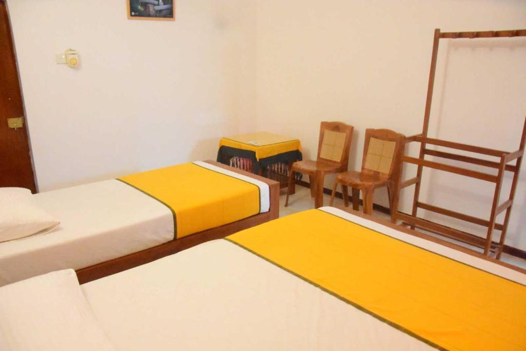 Postel nebo postele na pokoji v ubytování Yellow Birds Resort