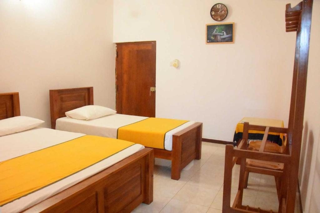 Postel nebo postele na pokoji v ubytování Yellow Birds Resort
