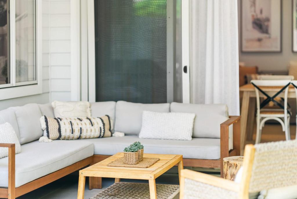 a living room with a couch and a table at Hamptons by Khove in Gold Coast