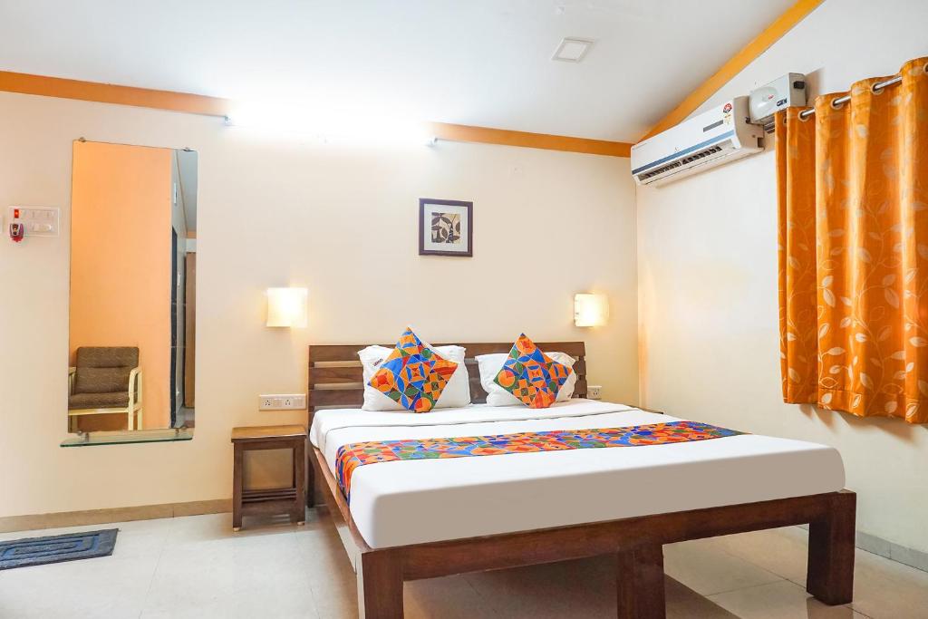a bedroom with a bed in a room at FabHotel Prime Vishwakirti Agri in Ahmadnagar